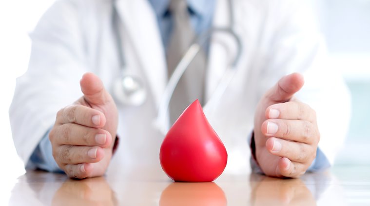 Doctor holding blood drop — blood donation awareness
