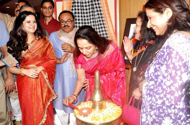 Hema Malini lighting traditional lamp at cultural inauguration